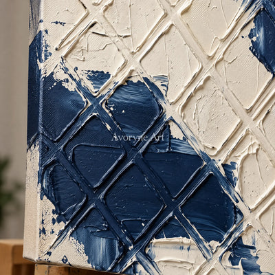 Close-up of the hand-painted texture of Weathered Current blue ivory grid wall art on an easel