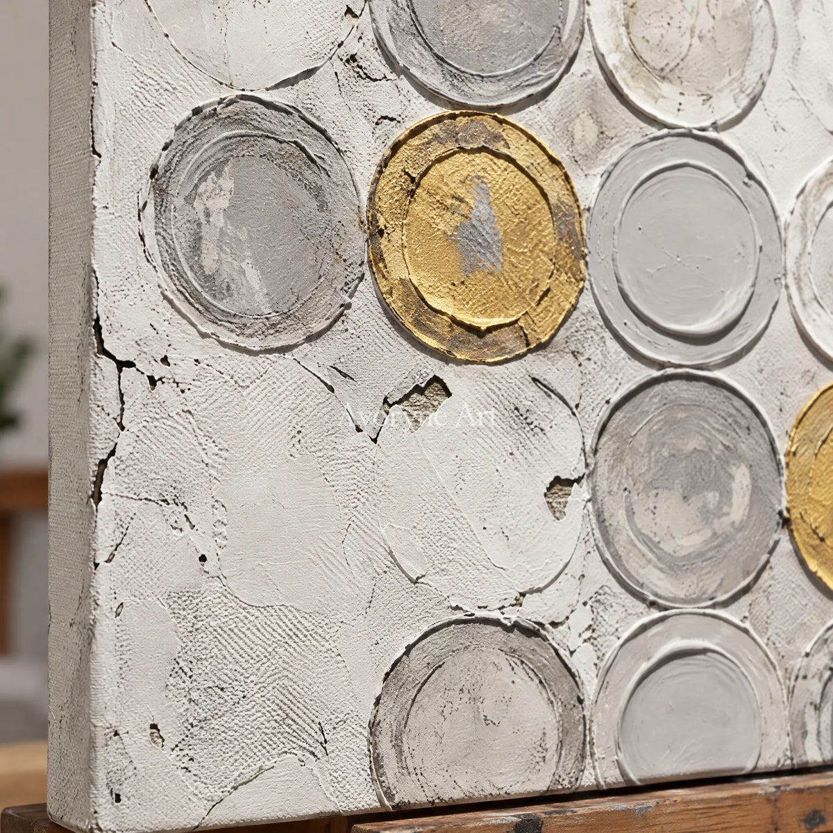 Close-up of the hand-painted texture of Soft Mosaic circle relief wall art on an easel