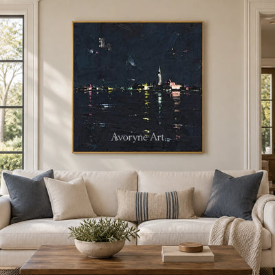 Still Trace cityscape wall art with a gold frame hanging in a living room