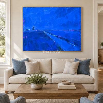Tender Verse cityscape wall art with a gold frame hanging in a living room
