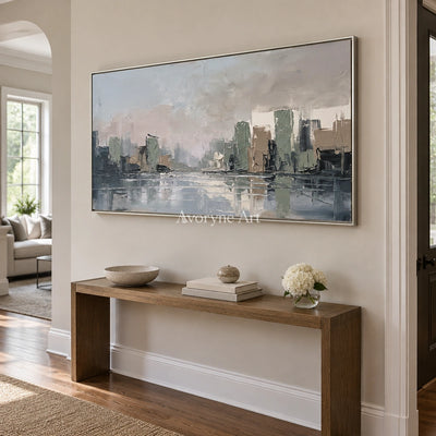 Bright Current cityscape wall art with a silver frame in an entryway