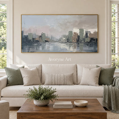 Bright Current cityscape wall art with a gold frame hanging in a living room