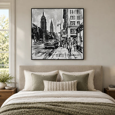 Silver Echo cityscape wall art with a black frame above a bed in a bedroom