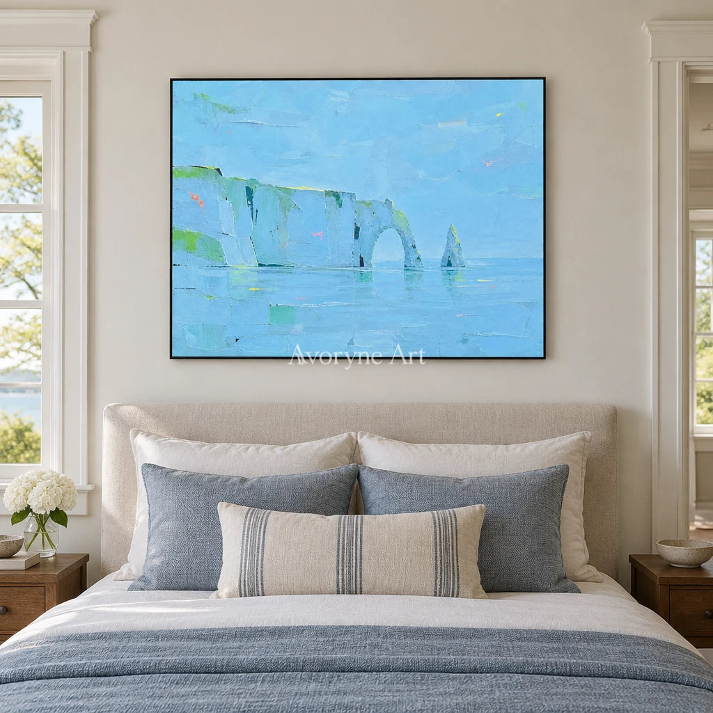 Tender Drift coastal landscape wall art with a black frame above a bed in a bedroom