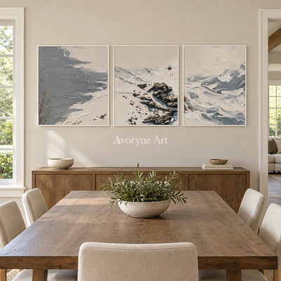 Restful Reverie coastal landscape triptych with a white frame in a dining room
