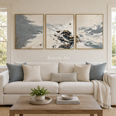 Restful Reverie coastal landscape triptych with a gold frame hanging in a living room