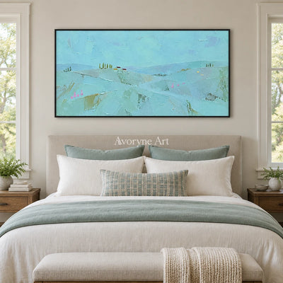 Still Story color block landscape wall art with a black frame above a bed in a bedroom