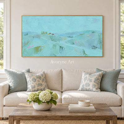 Still Story color block landscape wall art with a gold frame hanging in a living room