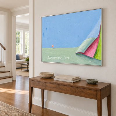 Still Vista color block landscape wall art with a silver frame in an entryway
