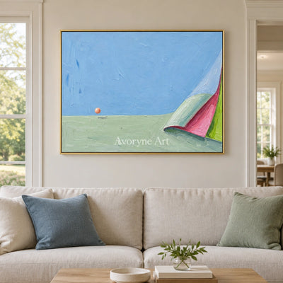 Still Vista color block landscape wall art with a gold frame hanging in a living room