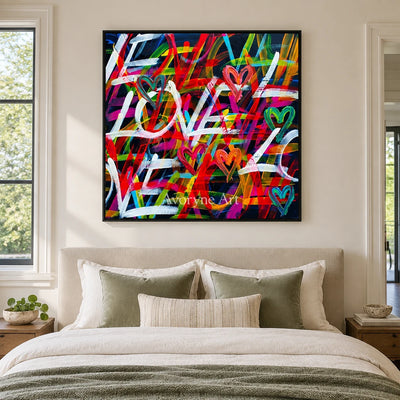 Hidden Memory colorful love wall art with a black frame above a bed in a bedroom