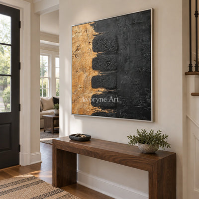 Quiet Measure dark mineral relief wall art with a silver frame in an entryway