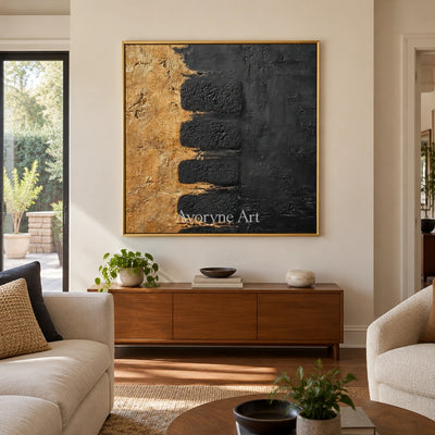 Quiet Measure dark mineral relief wall art with a gold frame hanging in a living room