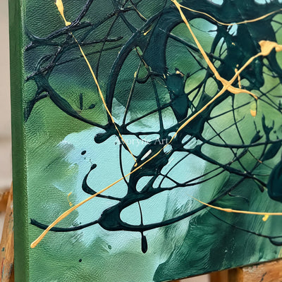 Close-up of the hand-painted texture of Golden Solace drip abstract wall art on an easel