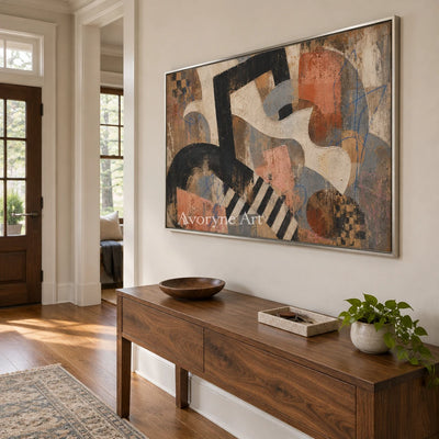 Woven Drift earth geometric art with a silver frame in an entryway