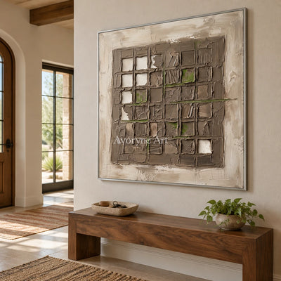 Weathered Horizon earth grid relief wall art with a silver frame in an entryway