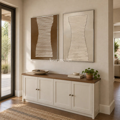 Muted Haven earth grooved curves diptych with a silver frame in an entryway