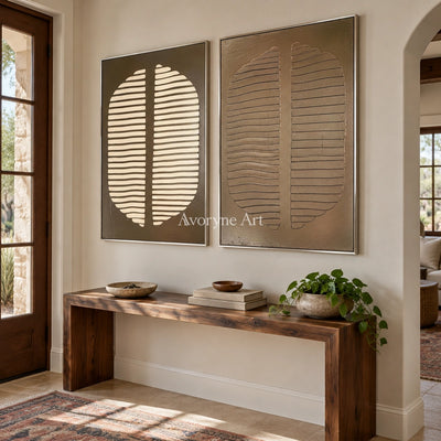 Muted Measure earth grooved curves diptych with a silver frame in an entryway