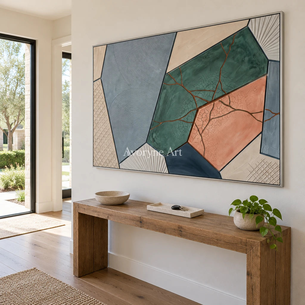 Still Refrain earth patch texture wall art with a silver frame in an entryway