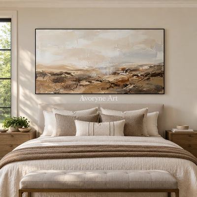 Bright Story earth tone landscape wall art with a black frame above a bed in a bedroom