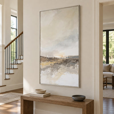 Bright Reverberation earth tone landscape wall art with a silver frame in an entryway