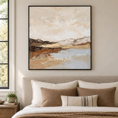 Bright Dialogue earth tone landscape wall art with a black frame above a bed in a bedroom