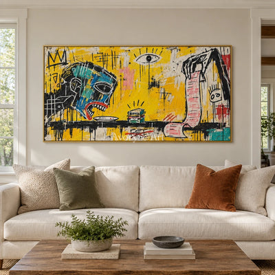 Gentle Solace graffiti figure wall art with a gold frame hanging in a living room