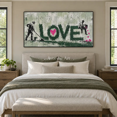Distant Mosaic graffiti figure wall art with a black frame above a bed in a bedroom
