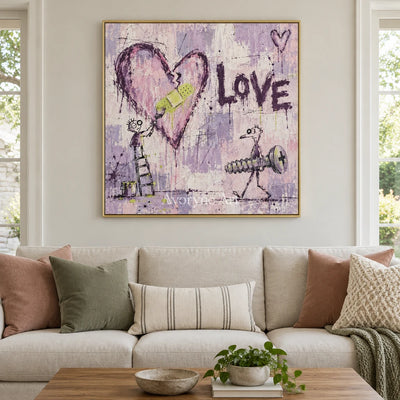 Distant Current graffiti figure wall art with a gold frame hanging in a living room