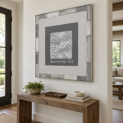 Hushed Echo gray scale relief wall art with a silver frame in an entryway