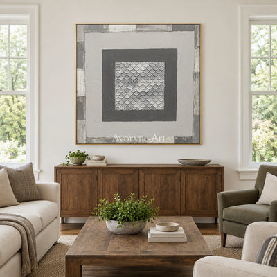Hushed Echo gray scale relief wall art with a gold frame hanging in a living room