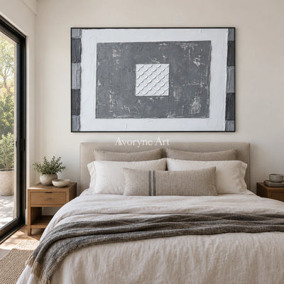Hushed Mosaic gray scale relief wall art with a black frame above a bed in a bedroom