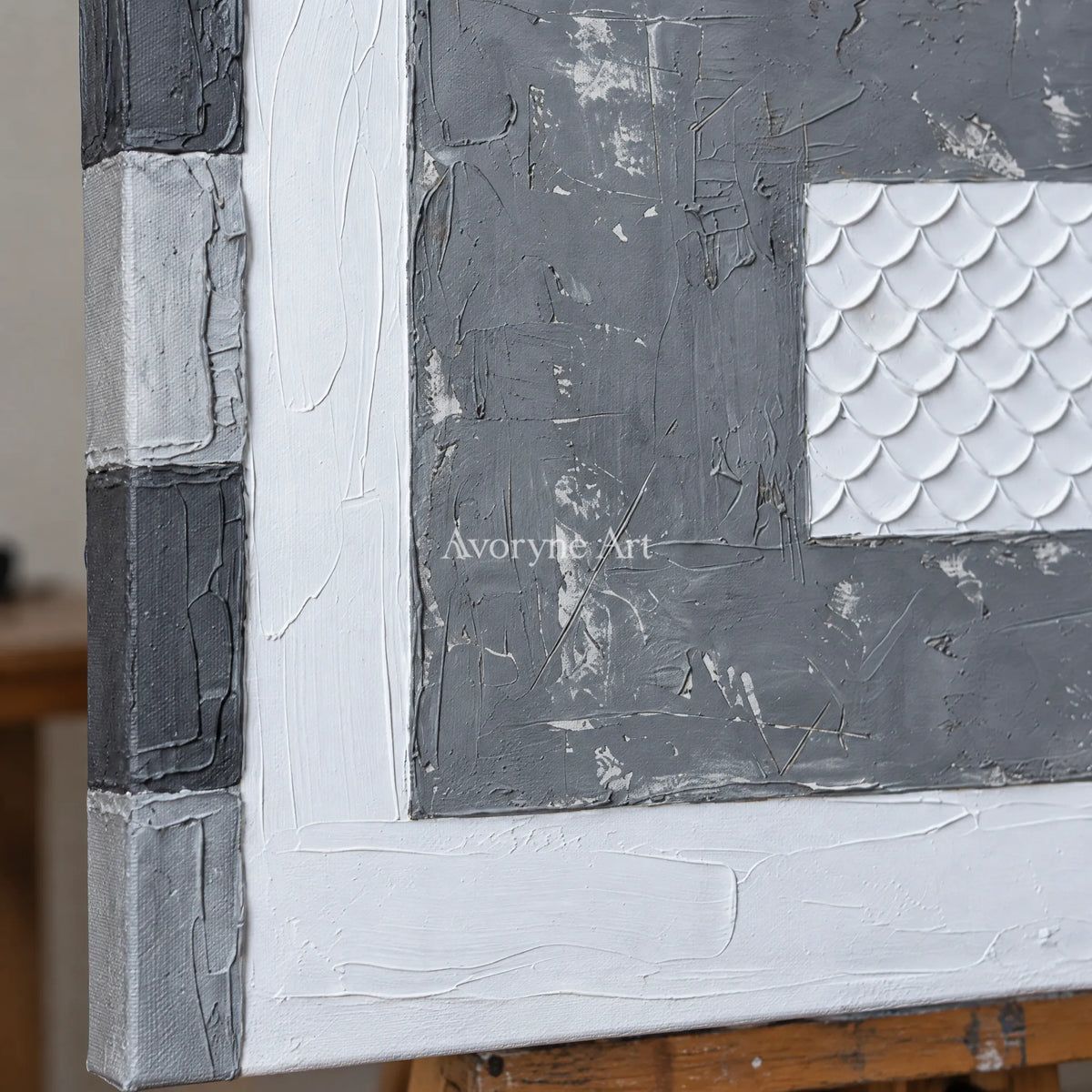 Close-up of the hand-painted texture of Hushed Mosaic gray scale relief wall art on an easel