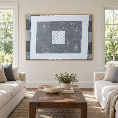 Hushed Mosaic gray scale relief wall art with a gold frame hanging in a living room
