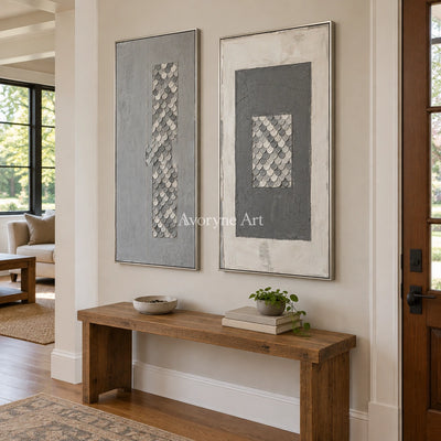 Hushed Reverie gray scale relief diptych with a silver frame in an entryway