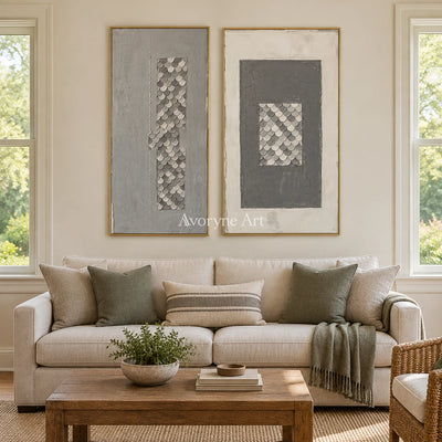 Hushed Reverie gray scale relief diptych with a gold frame hanging in a living room