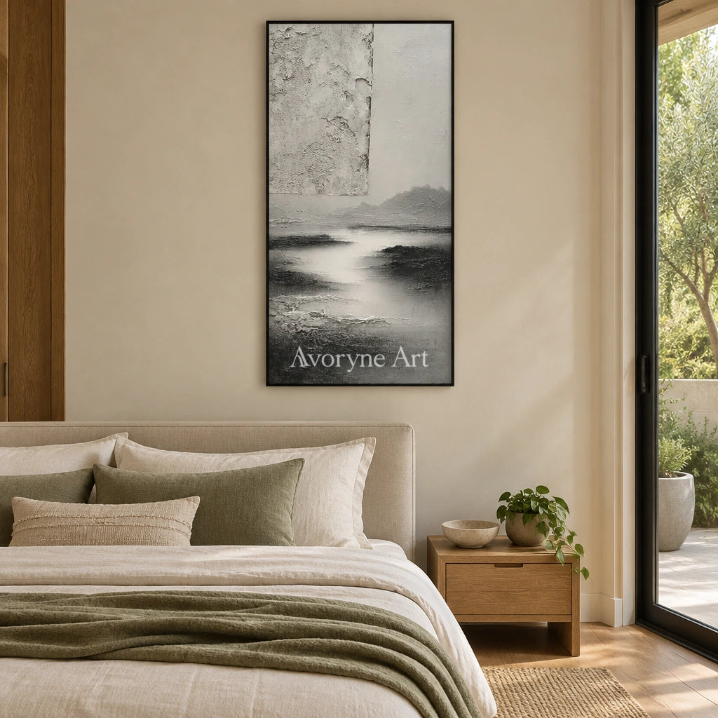 Pale Refrain gray water landscape wall art with a black frame above a bed in a bedroom