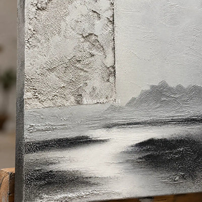 Close-up of the hand-painted texture of Pale Refrain gray water landscape wall art on an easel