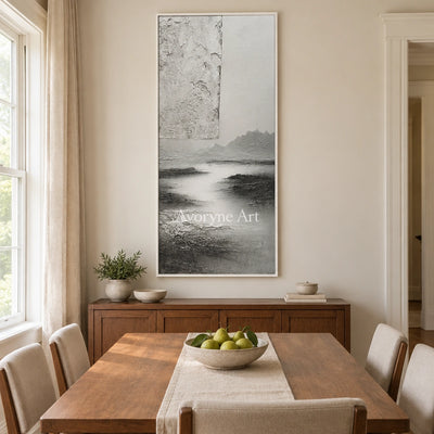 Pale Refrain gray water landscape wall art with a white frame in a dining room