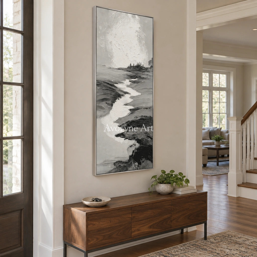 Pale Measure gray water landscape wall art with a silver frame in an entryway