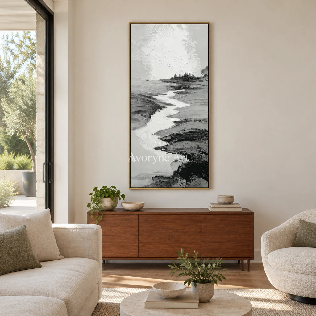 Pale Measure gray water landscape wall art with a gold frame hanging in a living room