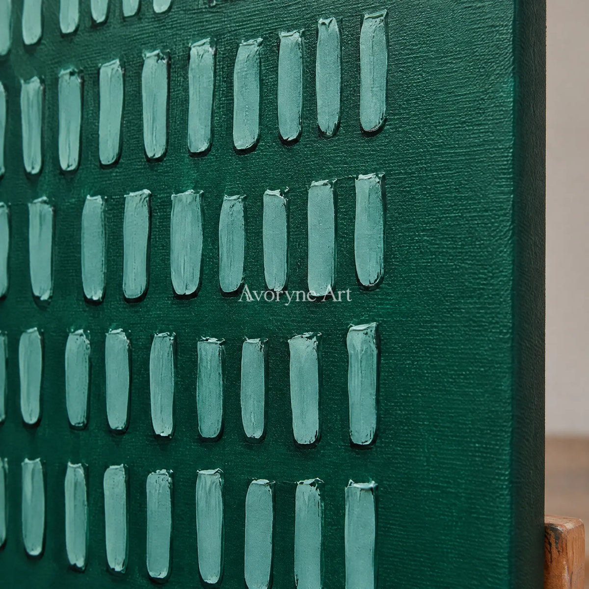 Close-up of the hand-painted texture of Muted Cadence green grid relief diptych on an easel