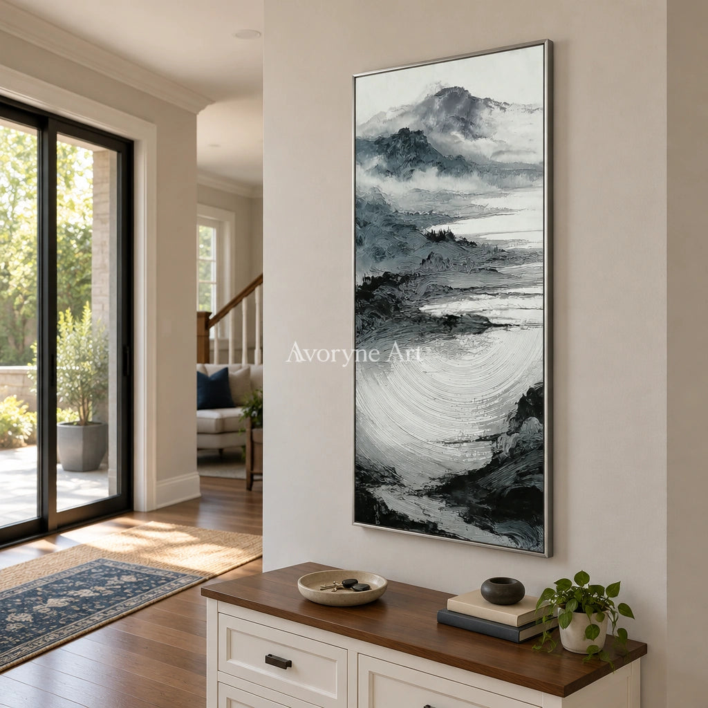 Pale Haven ink mountain water wall art with a silver frame in an entryway