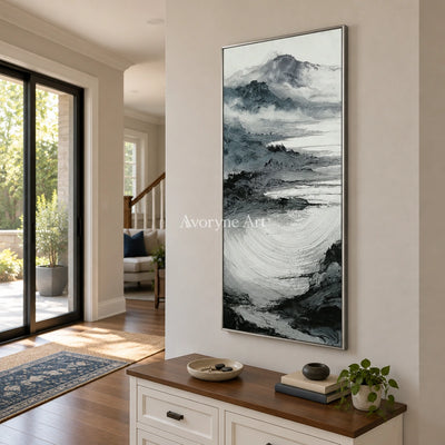 Pale Haven ink mountain water wall art with a silver frame in an entryway