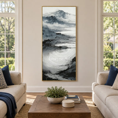 Pale Haven ink mountain water wall art with a gold frame hanging in a living room