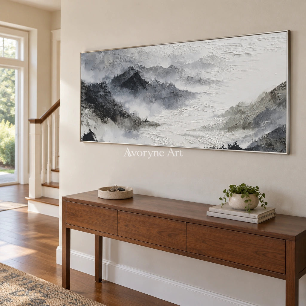 Pale Sonata ink mountain water wall art with a silver frame in an entryway