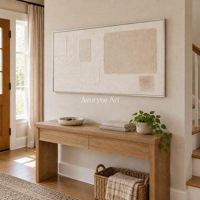 Woven Current ivory geometric art with a silver frame in an entryway