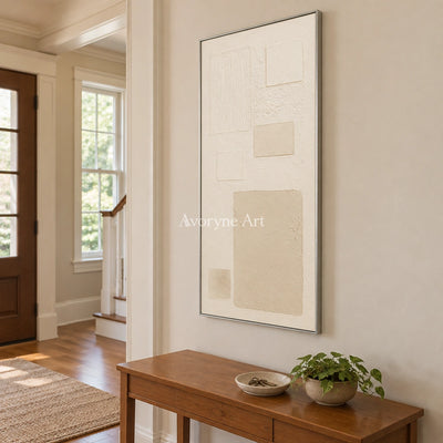 Woven Gesture ivory geometric art with a silver frame in an entryway