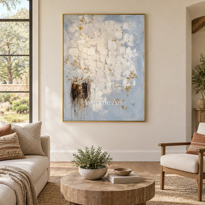 Gentle Haven ivory gold relief wall art with a gold frame hanging in a living room