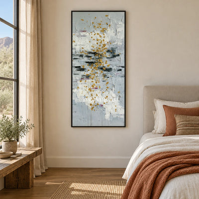 Gentle Measure ivory gold relief wall art with a black frame above a bed in a bedroom